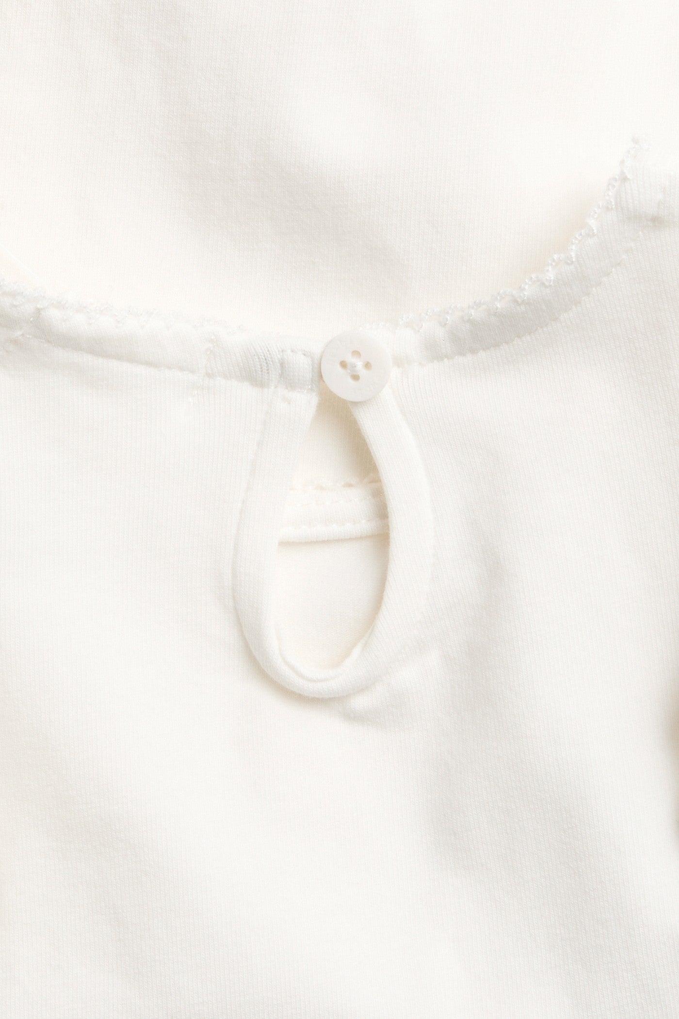 Baby white bodysuit with frills