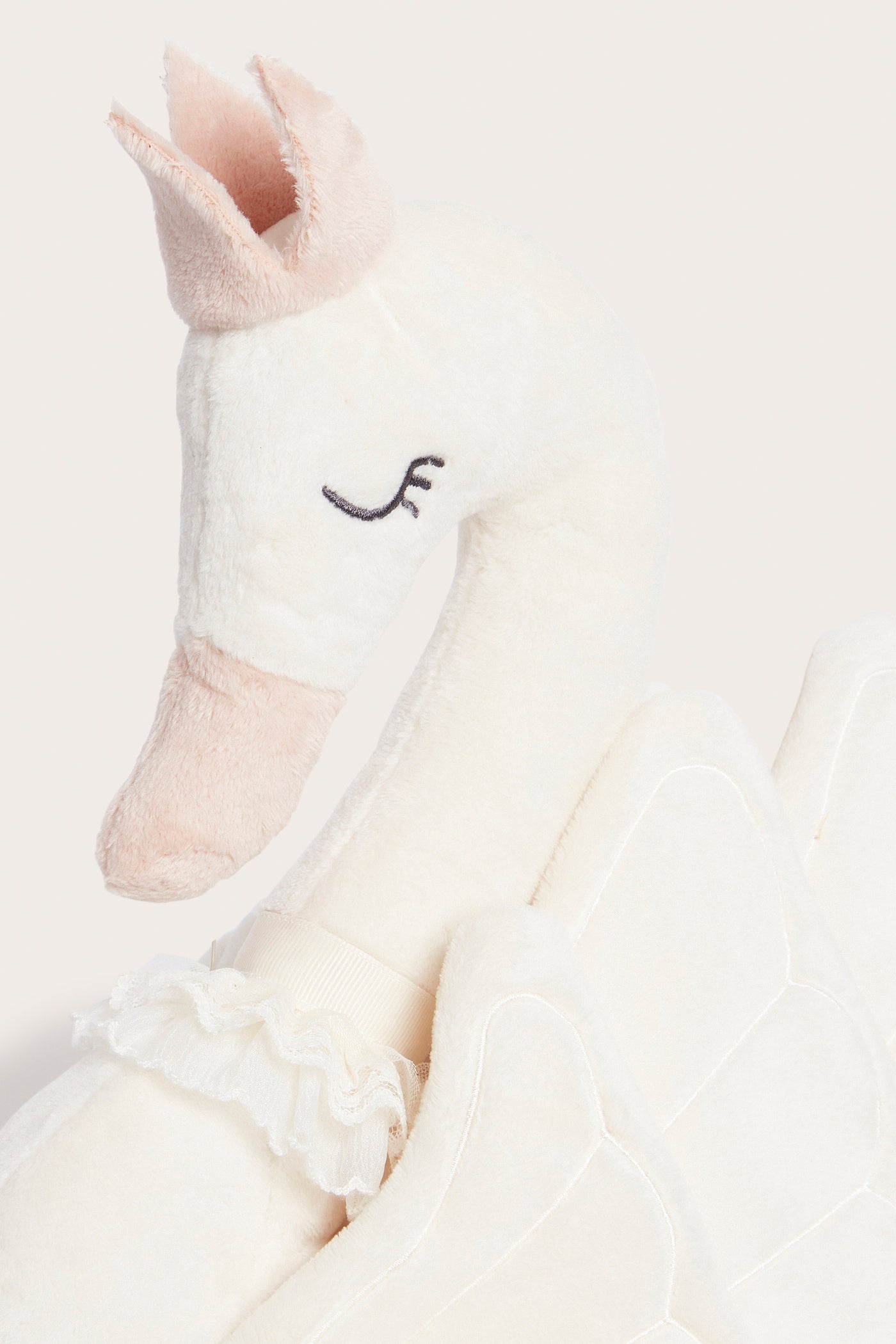 Swan‑shaped white cushion with crown