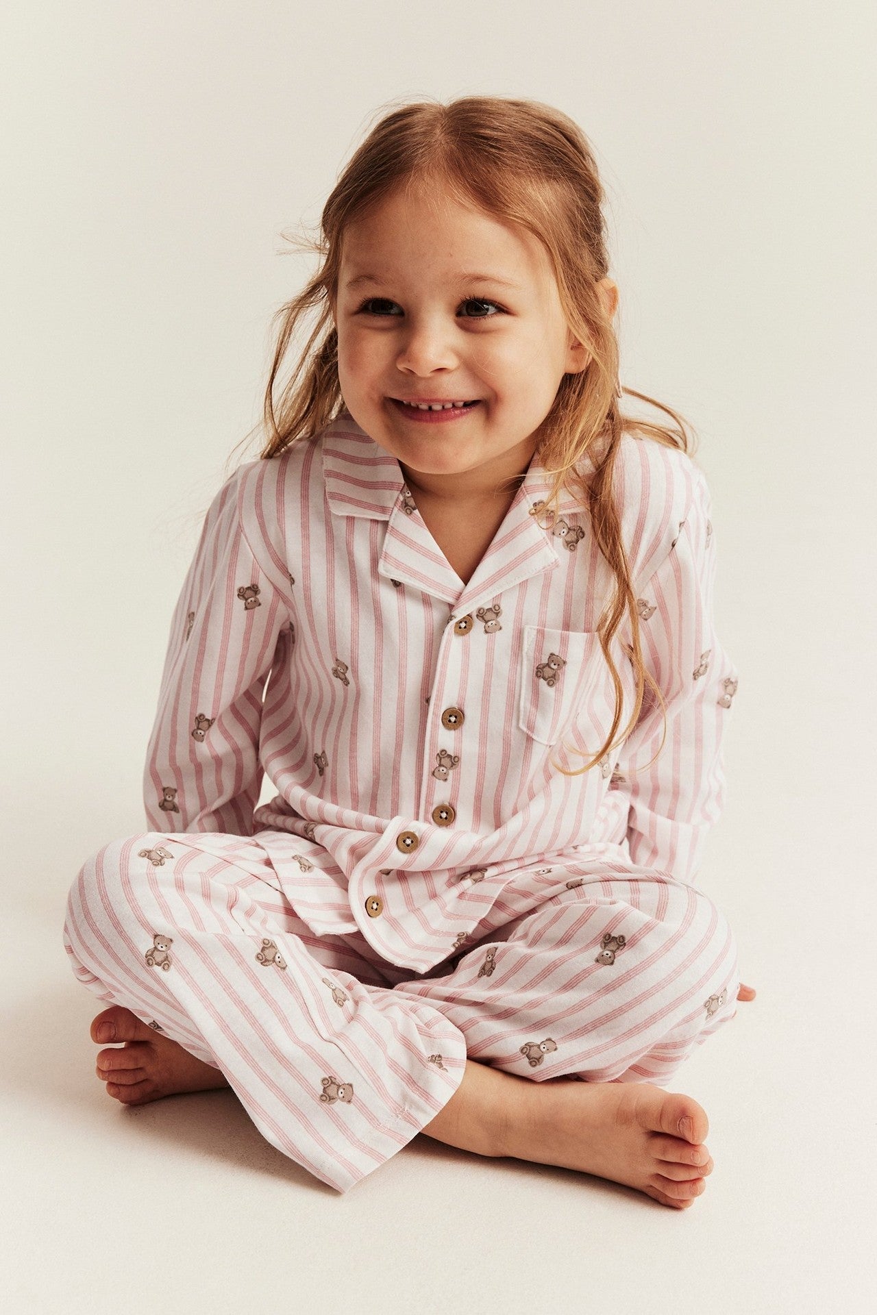 Kids striped pajamas with teddy bear motif